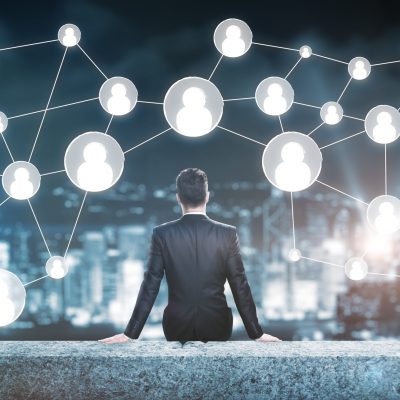 Man on rooftop looking at people icons. Human resources concept